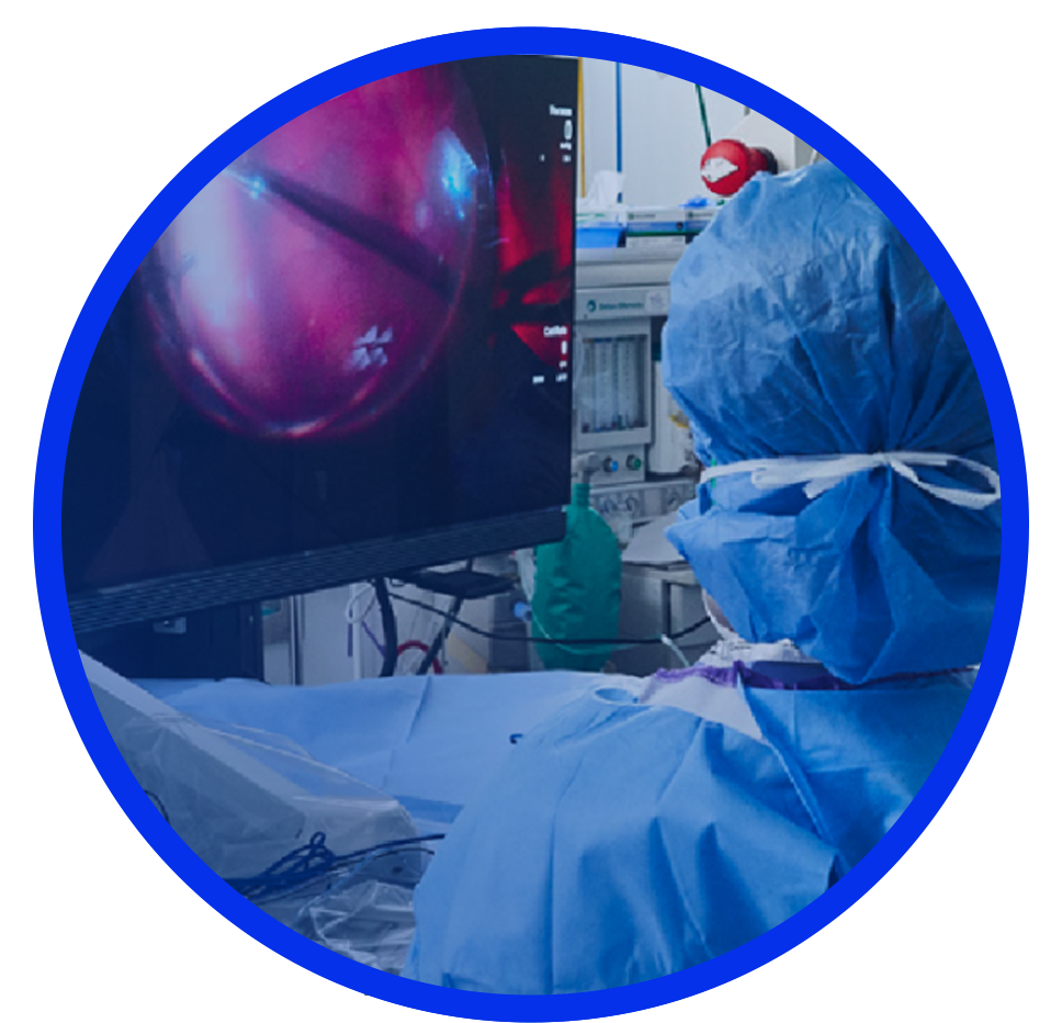 An image of a group of surgeons in an operating room with a patient undergoing surgery. An NGENUITY screen shows a close-up view of the surgery to the surgeons in the room.