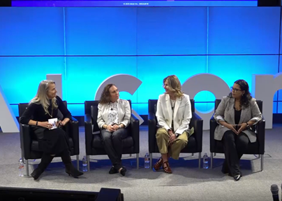 Long shot of 4 women sitting on a stage