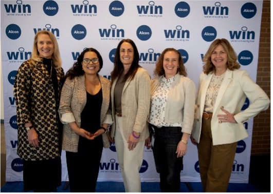 Group of women standing in front of Alcon WIN background
